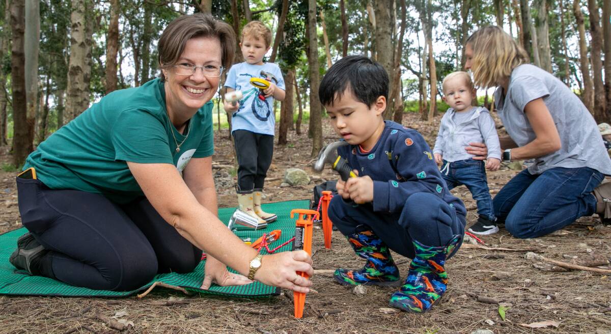 EXPLORE AND LEARN: Deborah Wood with some of her charges at a bush play session in Sydney Park. 