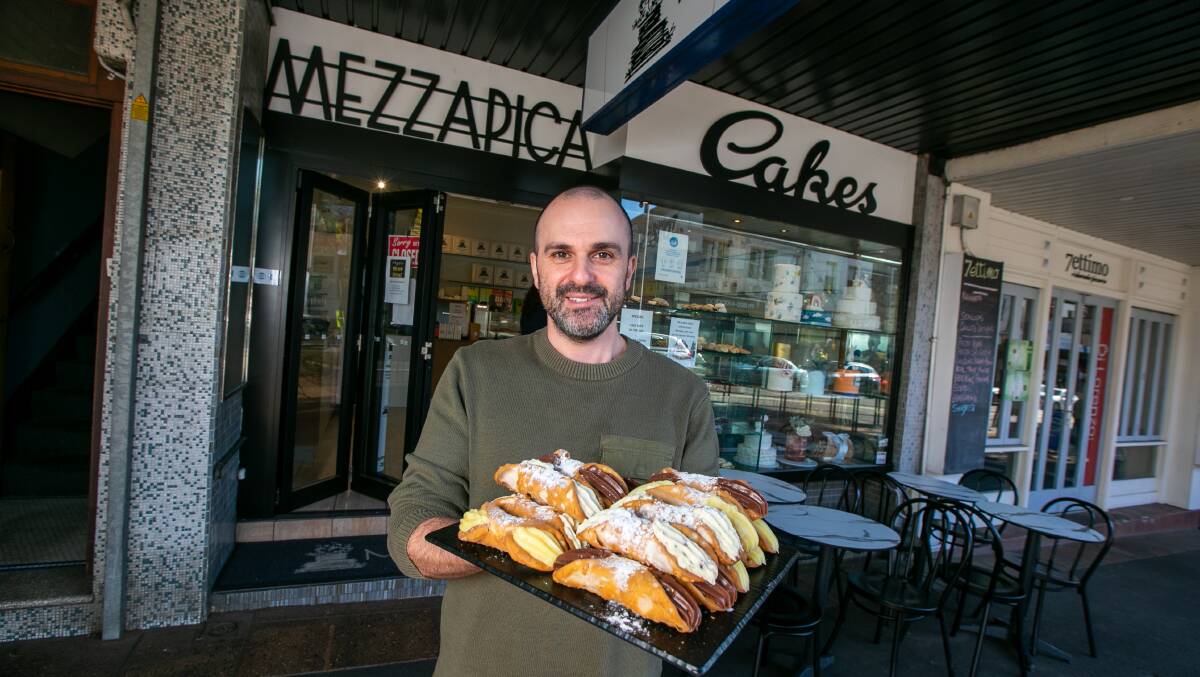 CRUNCHY GOODNESS: Andre Portelli, third-generation manager of his family's continental cake shop in Leichhardt, with a tray of cannoli. Picture: Geoff Jones