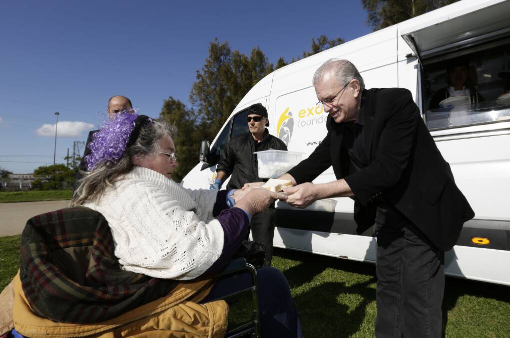 Bill Crews distributes food from a mobile van.