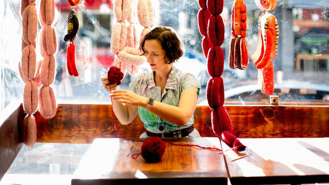 ONE AT A TIME: Chrissy Flanagan with her window display of knitted sausages.