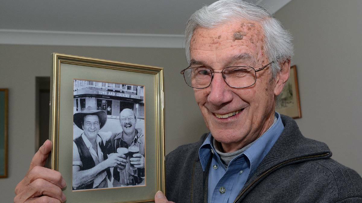 Songwriter Pat Aleander holds a photo of Slim Dusty and Duncan Urquhart outside the Town and Country. Picture: Paull Murray. 