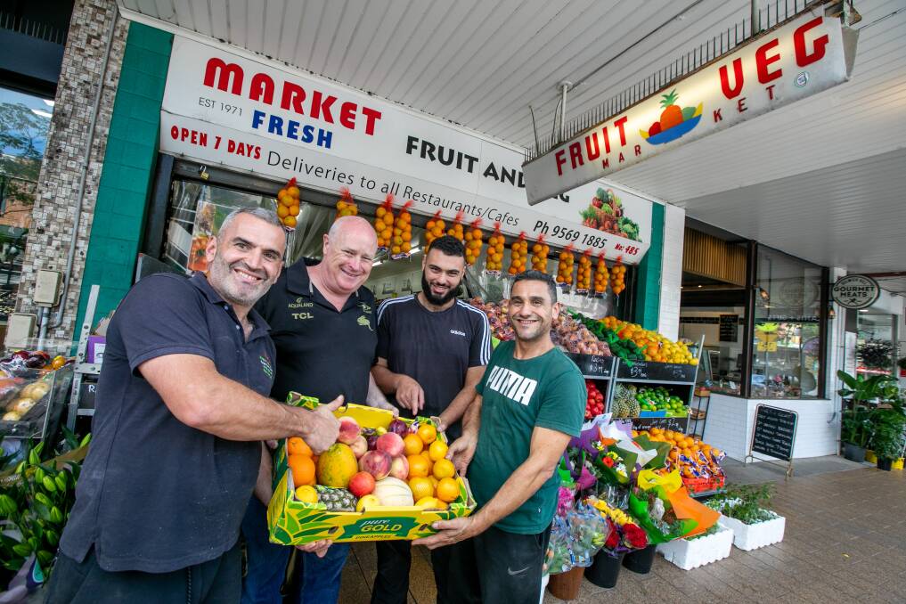 FRESH FRUIT: Paul Shiel with Fruit shop owners Ahmed Obeid (L), Mino Elkhaled and his son Ammar at the Dulwich Hill shop. Picture: Geoff Jones