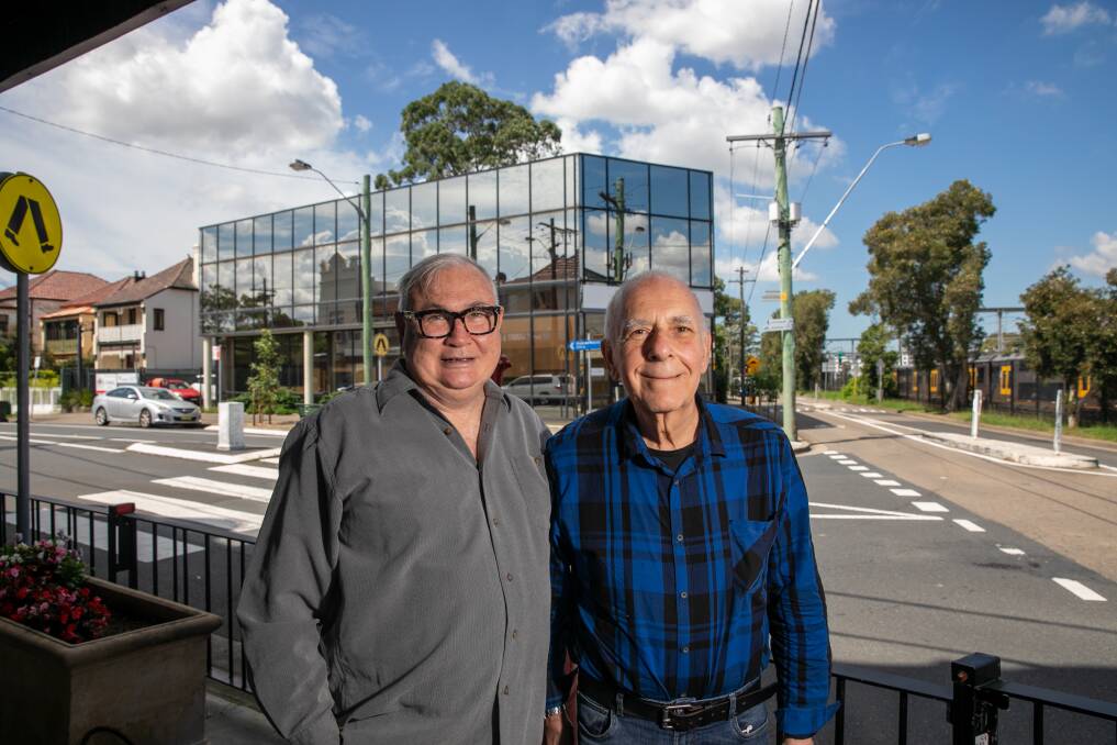 MEMORIES: Filmmaker and cinema historian Paul Brennan with Gary Zantos who visited the Summer Hill Theatre in its arthouse days in the 60s. Behind them is the office building that stands on the site of the demolished theatre. Picture: Geoff Jones 