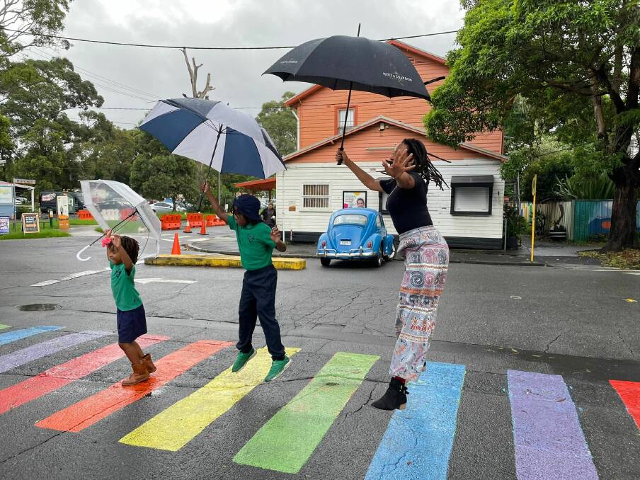 Kween G and her children pose on the rainbow crossing at the Addison Road Community Centre. Picture: 