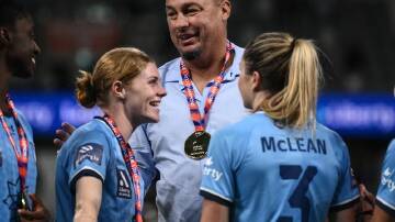 Courtnee Vine (left), coach Ante Juric and Charlotte Mclean celebrate Sydney's 2023 title. (James Gourley/AAP PHOTOS)