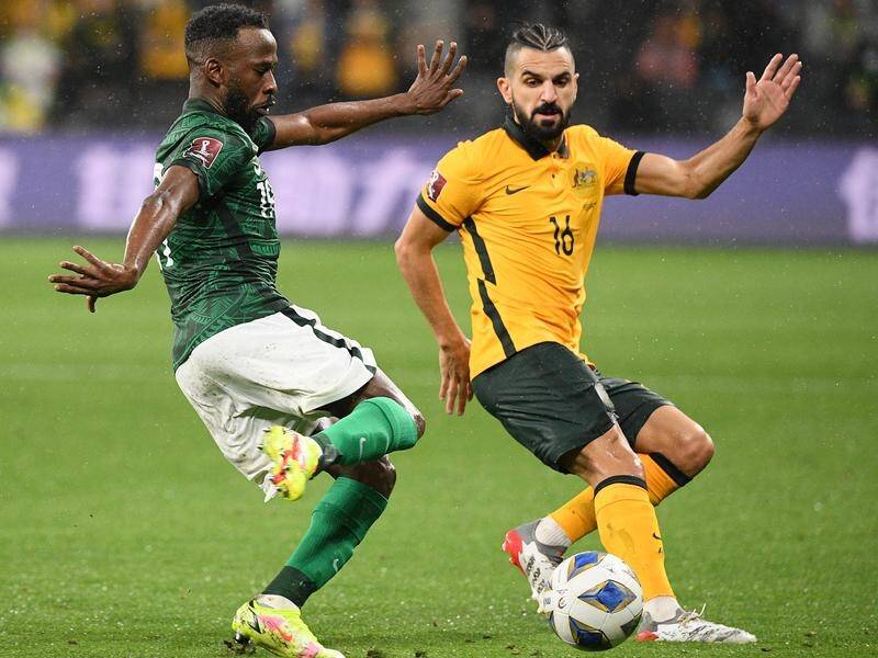 Defender Aziz Behich (R) will miss the Socceroos' World Cup qualifier against Vietnam in Melbourne.